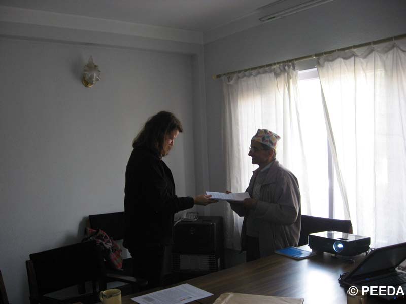 Kirsten Gade from EED signing the funding agreement for the bio-fuel project.